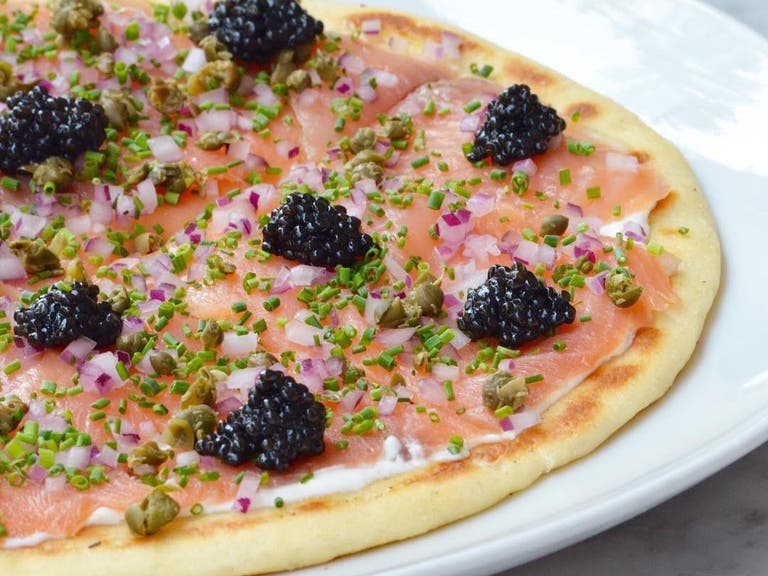 Smoked salmon and caviar flatbread at Petrossian LAX Tom Bradley International Terminal | Photo: @petrossianlax, Instagram